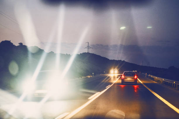 Night traffic on highway in a remote location in Izmir, Turkiye. Close-up of an ophthalmologist using a device for an eye exam in a medical clinic setting.